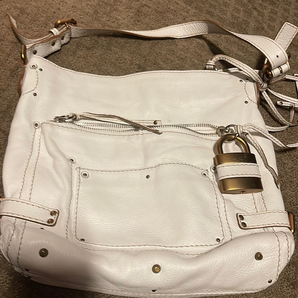 Beautiful white leather shoulder bag. Very roomy and great for traveling.